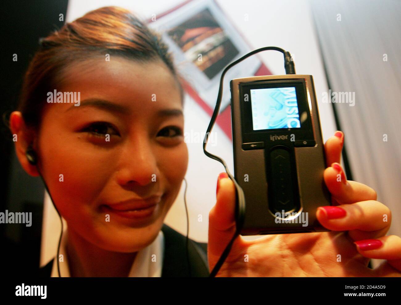 A promoter displays South Korea's portable multi-media player brand  ReignCom Co.Ltd's new mini Hard Disk Drive (HDD) type MP3 player 'iriver  H10' during its launch in Seoul December 16, 2004. The new