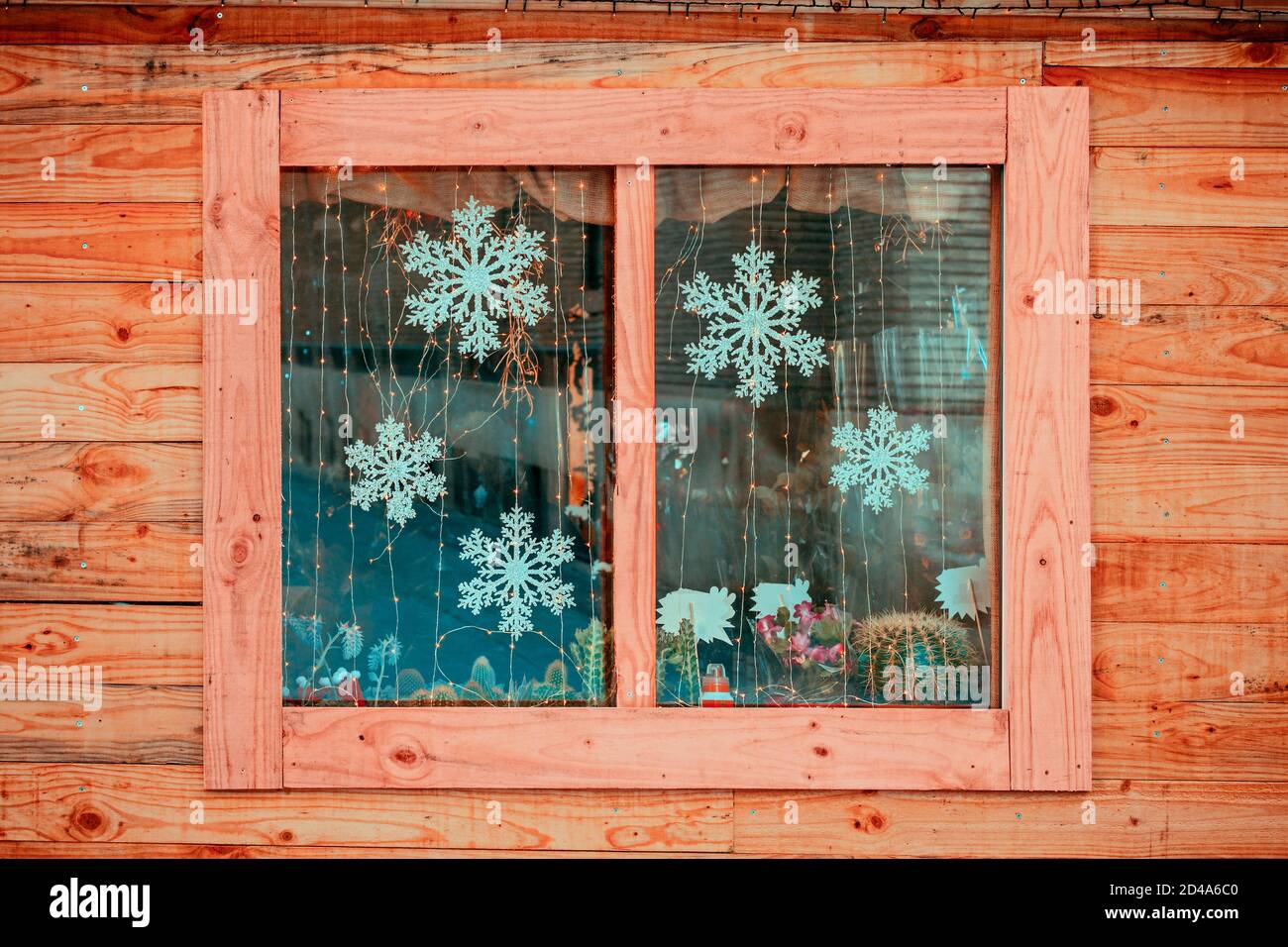 view of wooden facade with Window showing Christmas motifs Stock Photo