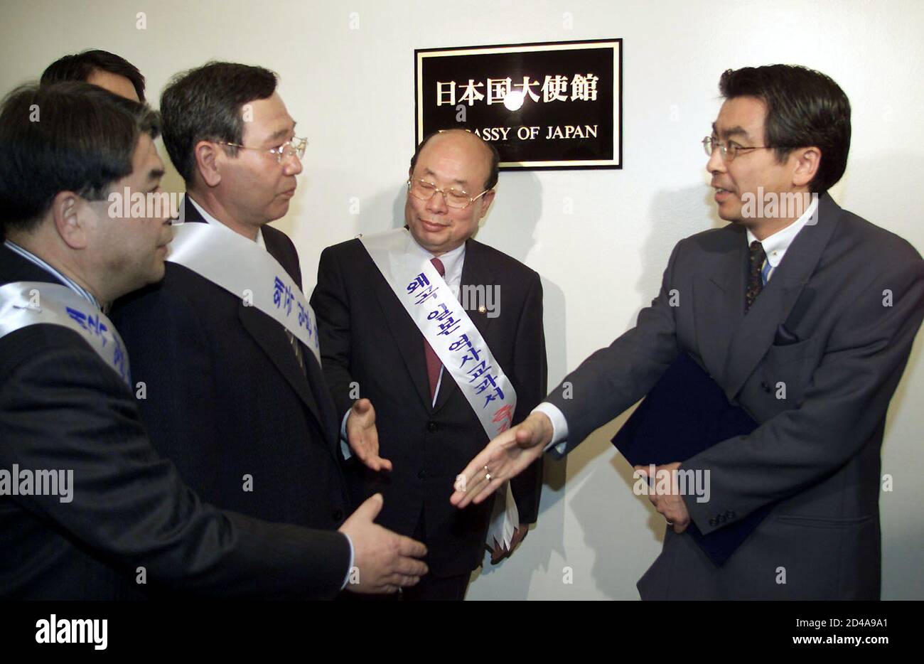 Sugiyama Shinsuke (R), a staff member of the Japanese Embassy in Seoul talks Rhee Q-taek (2nd L), the chairman of a committee of the Education and Human Resources Development of the South Korean National Assembly in Seoul April 9, 2001 as he meets other South Korean lawmakers. Seven South Korean lawmakers delivered a letter to the Japanese Embassy on Monday to protest the revision of a high school history textbook in Japan which glosses over its 1910-1945 colonisation of the Korea peninsula.  YUN/PB Stock Photo