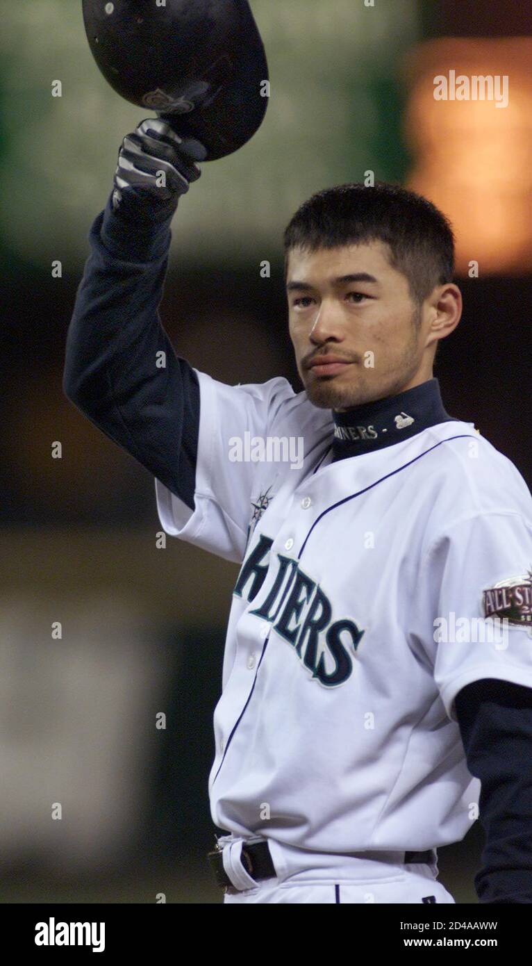 Seattle Mariners' All-Star Ichiro Suzuki tips his batting helmet to a  standing ovation from the crowd after he batted his 234 hit of the season,  a single to centerfield, during the fourth