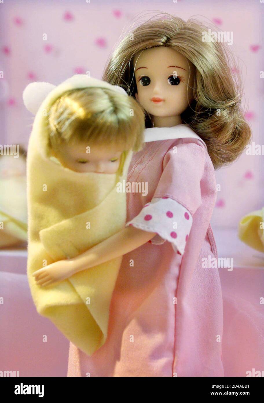 A pregnant edition "Licca-chan" doll, Japan's widely popular version of  Barbie, holds her baby at Hakuhinkan toystore in Tokyo's Ginza shopping  district November 19, 2001. Delivery of the baby comes some two