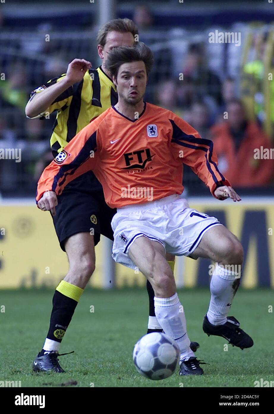 Borussia Dortmund's Joerg Heinrich (L) tackles 1860 Munich's Austrian Harald Cerny (R) from during a German first division soccer match in Dortmund April 6, 2002. REUTERS/ Ina Fassbender  INA Stock Photo