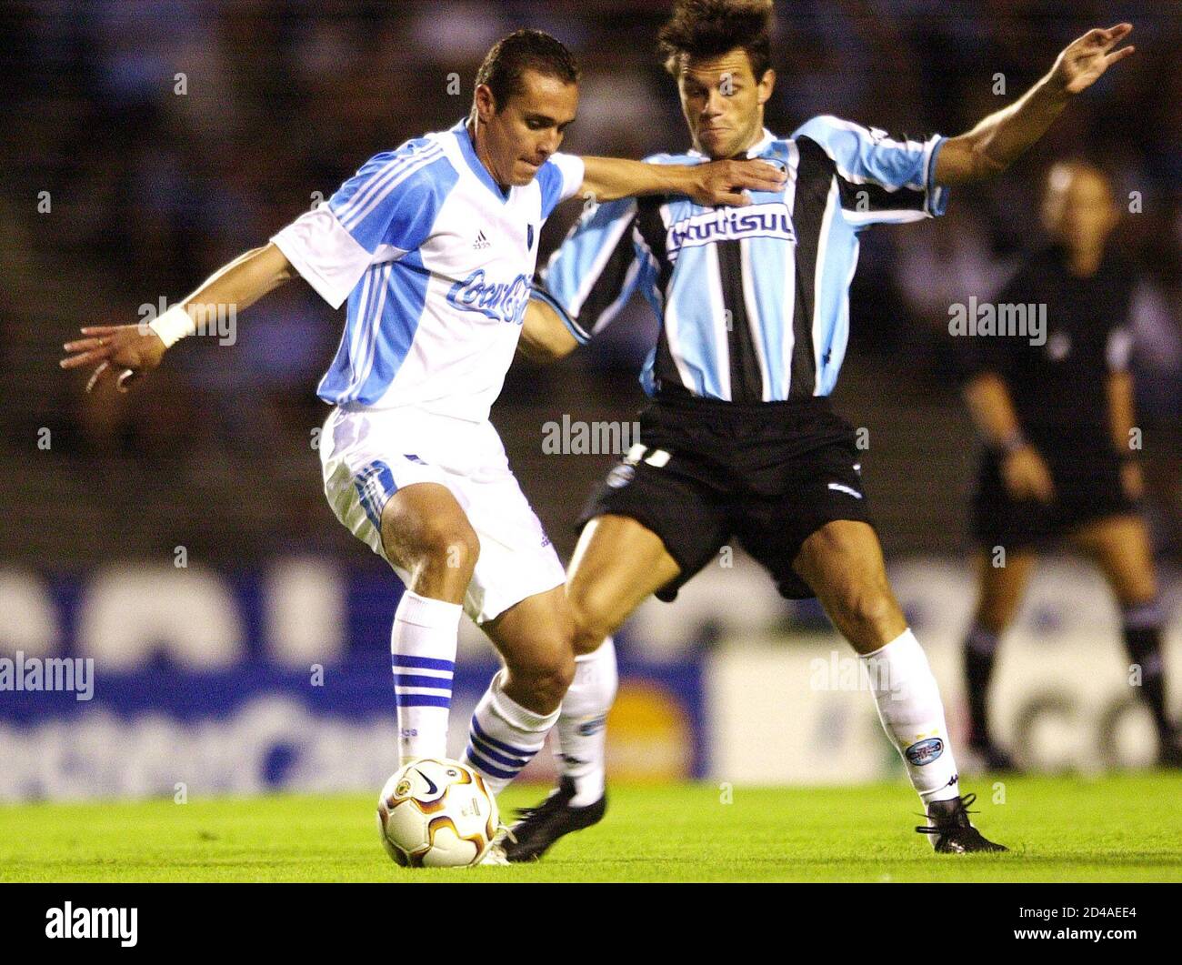 Ruben Tufino (L) of Bolivian soccer club Bolivar is tackled by Rodrigo  Fabri of Brazilian club Gremio during their Copa Libertadores soccer match  at Olimpico stadium in Porto Alegre, March 13, 2003.