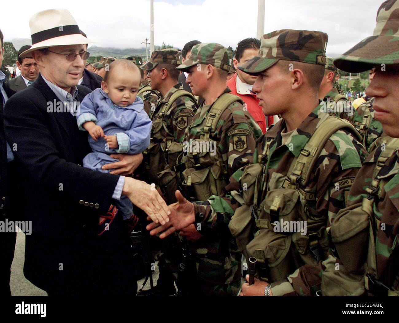 Colombian President Alvaro Uribe greets a new soldiers in Guasca, in the province of Cundinamarca, June 16, 2003. 10,000 new peasant soldiers are being sworn into service on Monday across the country. The Colombian army capturing 58 suspected Marxist guerrillas in weekend raids and said on Monday it believed the operation had dealt a blow against rebel plans to carry out attacks in the capital. Those held are alleged members of the Revolutionary Armed Forces of Colombia, a 17,000-strong force known by the Spanish initials FARC. REUTERS/Daniel Munoz  DM/GN Stock Photo