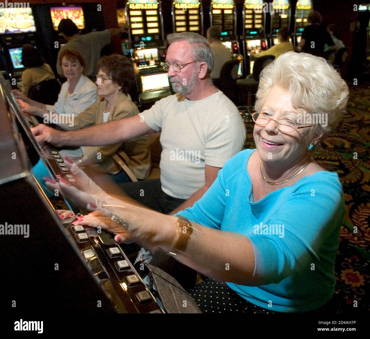 Deborah Phillips and her husband Charlie Phillips of Vero Beach, Florida, play video poker at Binion's Horseshoe Hotel & Casino after it reopened under the operation of Harrah's Entertainment, Inc. in Las Vegas, Nevada, April 1, 2004. The landmark casino had been closed since federal marshals and Nevada gaming regulators closed it down in January. The Phillips' said they came to Las Vegas specifically for the hotel's reopening. REUTERS/Las Vegas Sun/Ethan Miller  EM/HB Stock Photo