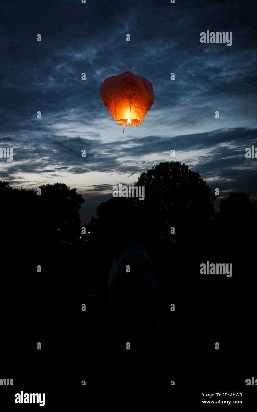 Sky lanterns released into the night sky in a commemorative celebration
