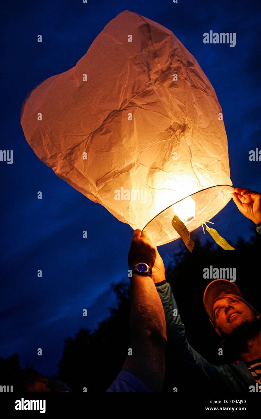 Sky lanterns released into the night sky in a commemorative celebration