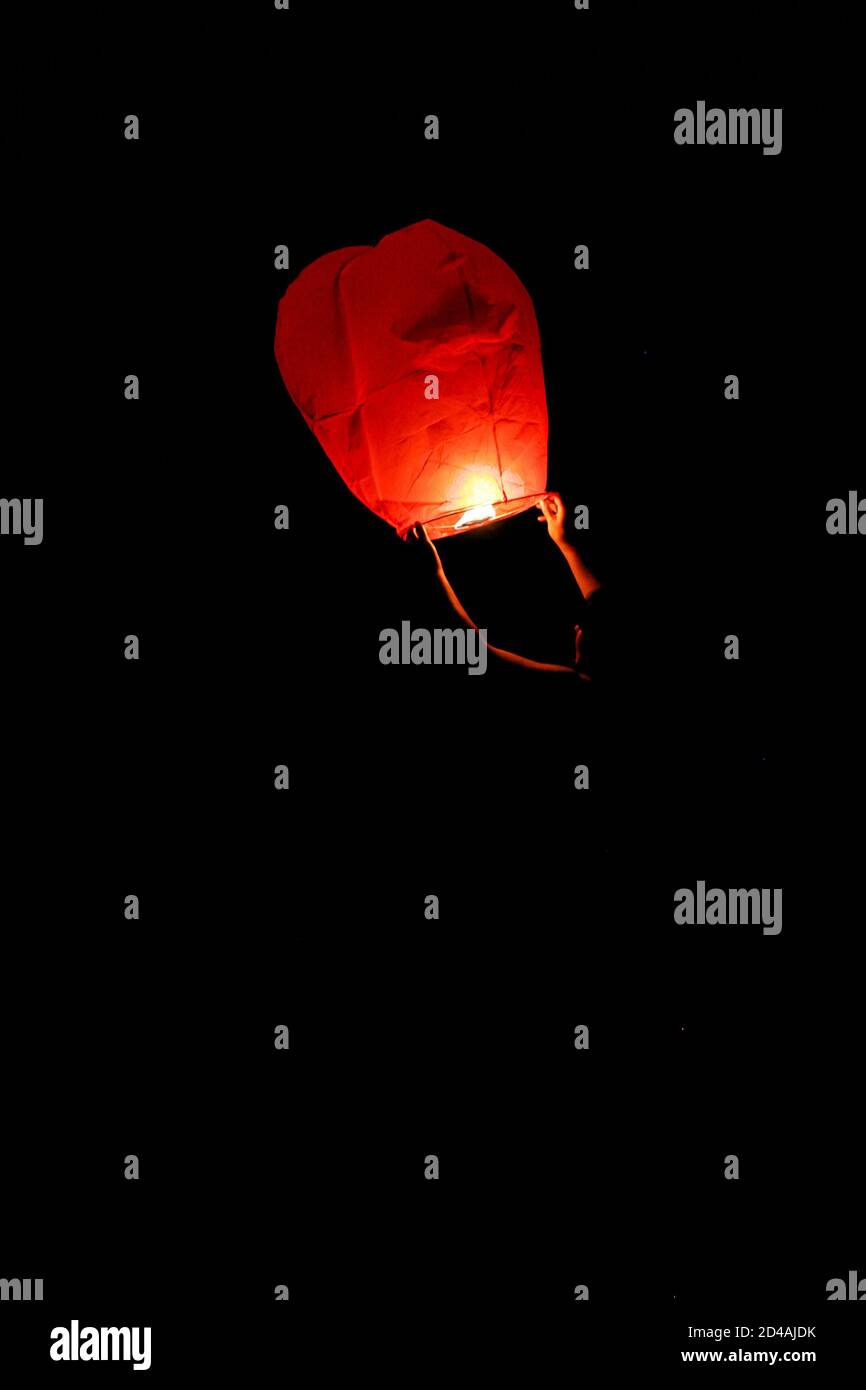 Sky lanterns released into the night sky in a commemorative celebration