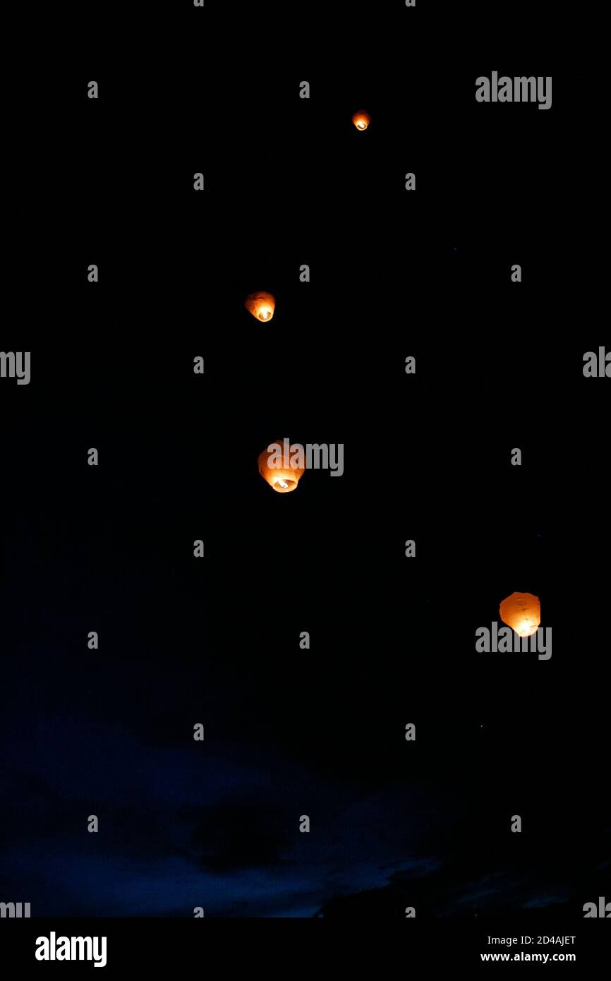 Sky lanterns released into the night sky in a commemorative celebration