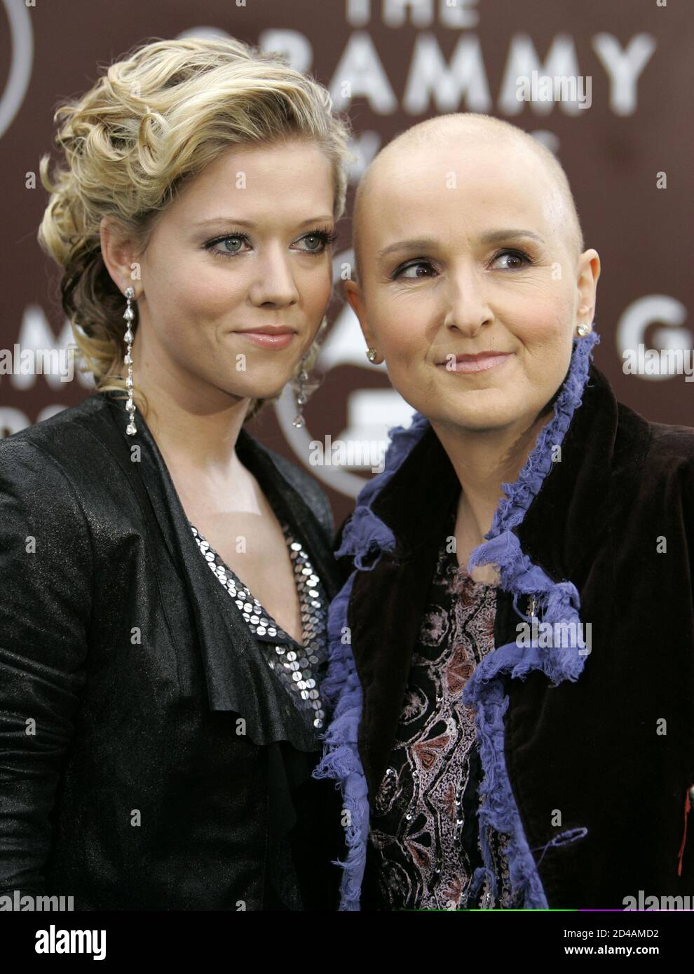 Singer Melissa Etheridge, without hair due to chemotheraphy treatments,  poses with her life partner actress Tammy Lynn Michaels as they arrive at  the 47th annual Grammy Awards at the Staples Center in
