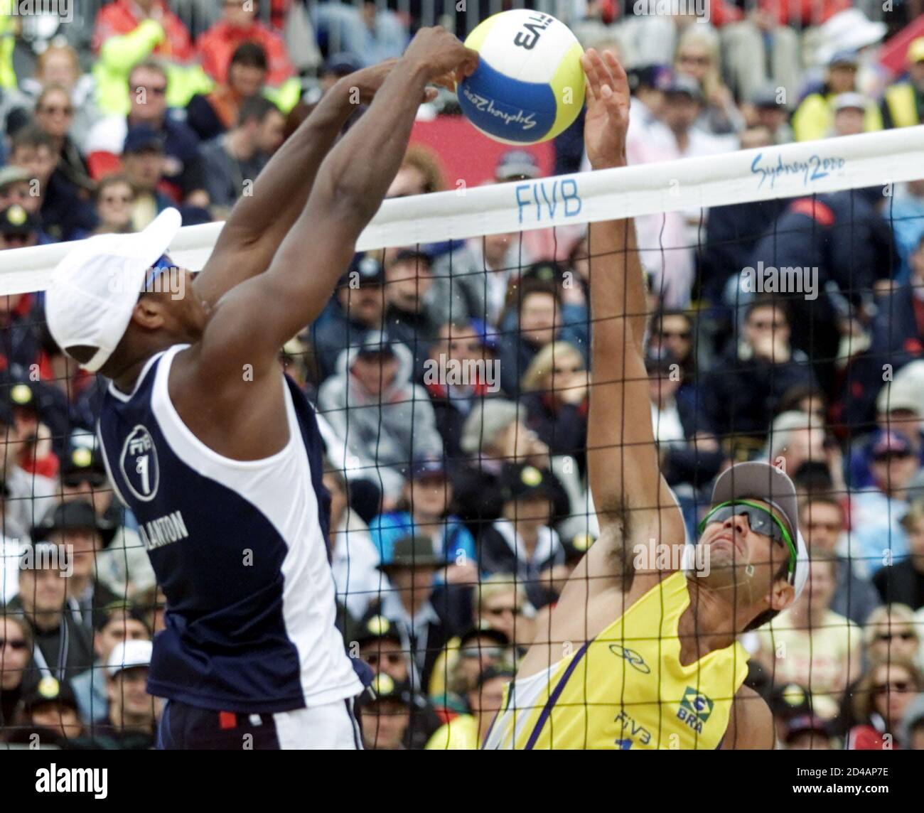 American Dain Blanton (L) and Brazilian Ze Marco jump during their beach volleyball gold medal match at Bondai Beach, September 26, 2000. Americans duo Blanton and Fonoimoana defeated the Brazilian team 12-11 12-9. PW Stock Photo