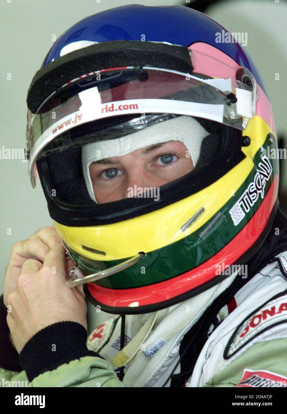 Canadian Bar-Honda driver Jacques Villeneuve adjusts his helmet during the  morning warm up at the Hungaroring on August 19,2001. German Ferrari driver  Michael Schumacher, who will start from the pole position ahead