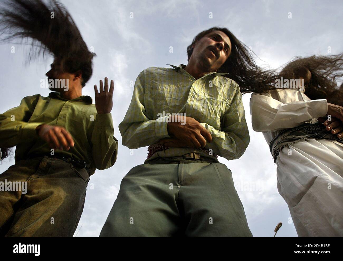 Waving with their long hair outside their tekiyah in Baghdad, Iraqi Dervishes pray during their gathering May 29, 2003. Swaying gently at first, chanting in monotones, the Dervishes slowly build up to Waving with their long hair outside their tekiyah in Baghdad, Iraqi Dervishes pray during their gathering May 29, 2003. Swaying gently at first, chanting in monotones, the Dervishes slowly build up to