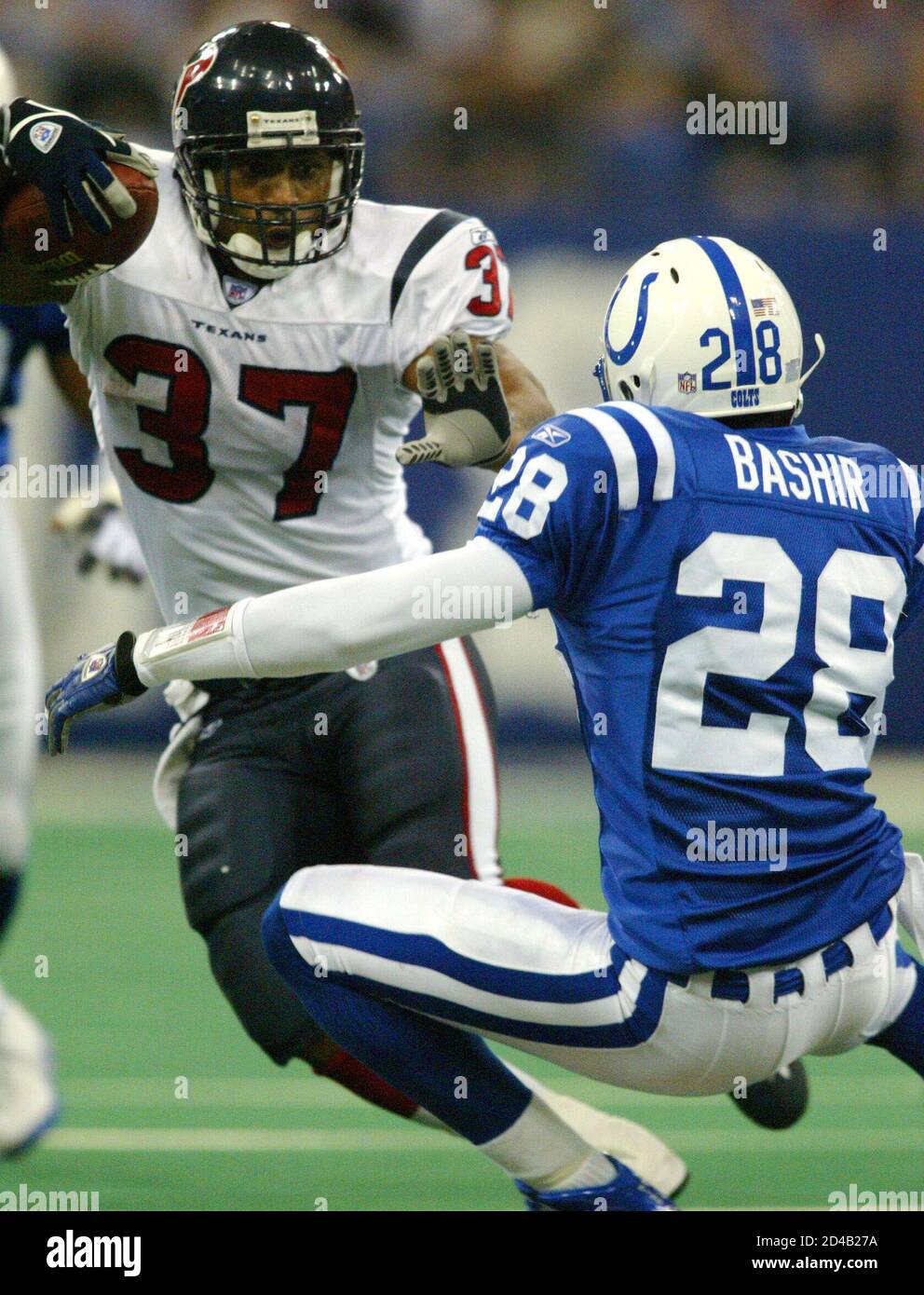 Houston Texans running back Domanick Davis (37) stiff-arms Indianapolis Colts defensive back Idrees Bashir (28) on his way to a second-quarter touchdown, October 26, 2003 at the RCA Dome in Indianapolis. Davis ran for 15 yards on the play. REUTERS/Brent Smith  BS/GAC Stock Photo