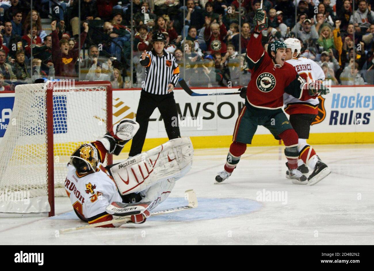 Minnesota Wild left wing Pascal Dupuis after a goal by teammate Sergei  Zholtok, past Calgary Flames goalie Miikka Kiprusoff (L) during the second  period of their NHL game, at the Xcel Energy