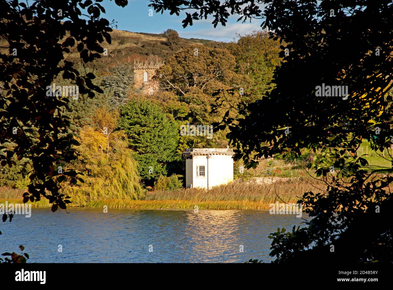 Edinburgh, Scotland, UK. 9 October 2020. Cool temperature of seven degrees  with a breeze, Pictured: Duddingston Loch with the morning sun shining on  Thomson's Tower in mid ground and Duddingston Kirk nestled
