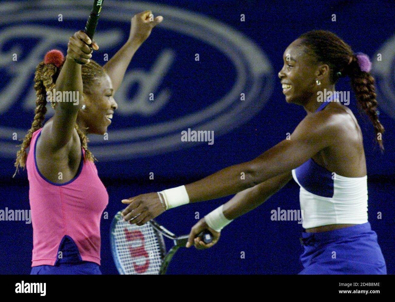 The United States pair of Serena Williams (L) and her sister Venus run into  each others arms as they celebrate their win in the Women's Doubles final  against compatriots Lindsay Davenport and