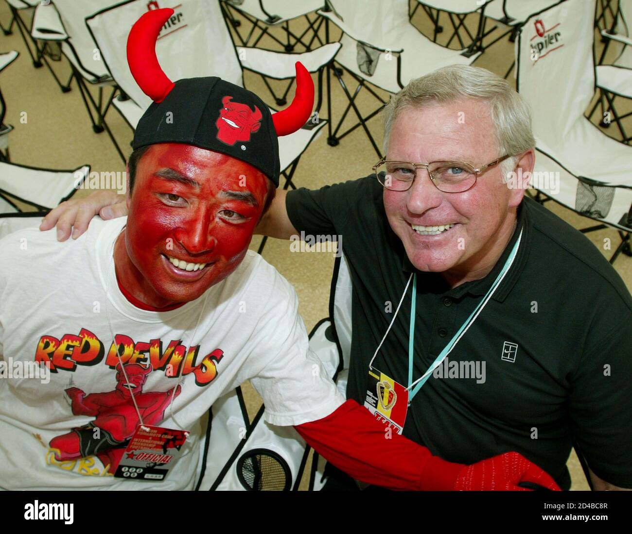 Belgium S National Team Coach Robert Waseige L Poses With Soccer Fan Mitsuo Matsuoka R Dressed As A Red Devil The Nickname For The Belgian Team After A Training Session At The Kk