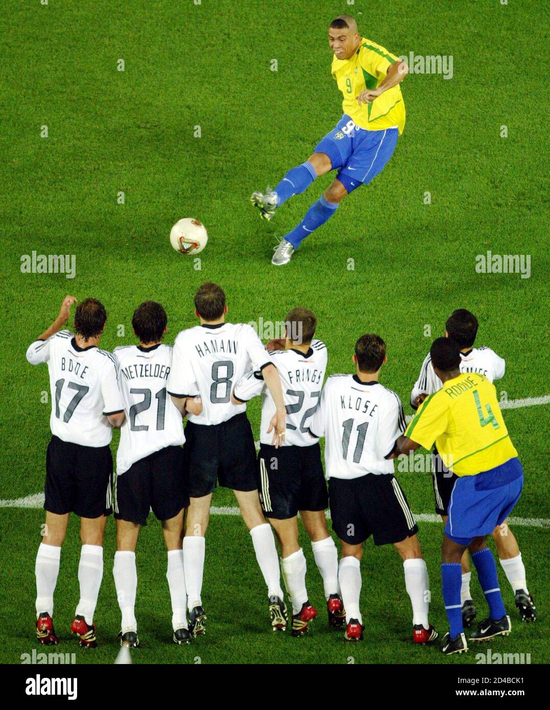 Brazil's Ronaldo (top) makes a free kick as Germany's (R-L) Jens Jeremies,  Miroslav Klose, Torsten Fings, Dietmar Hamann, Christoph Metzelder, and  Marco Bode defend their goal in the second half of their