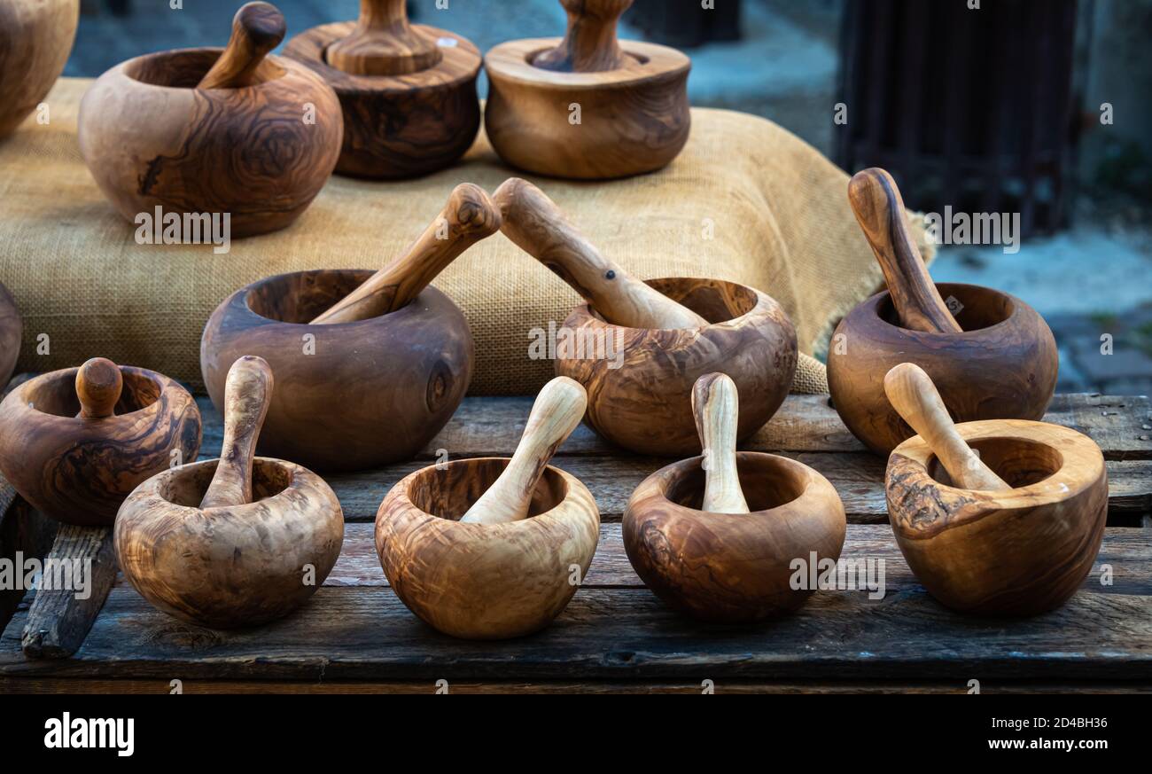a selection of wooden mortar and pestle made from olive wood on market