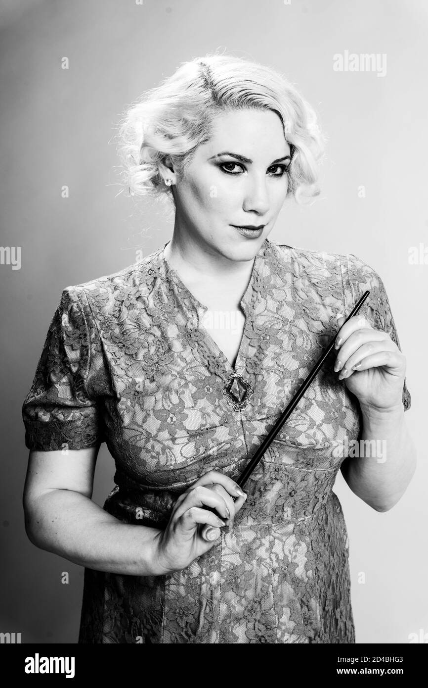 Grayscale shot of a blonde female dressed as a fairy in a studio Stock Photo