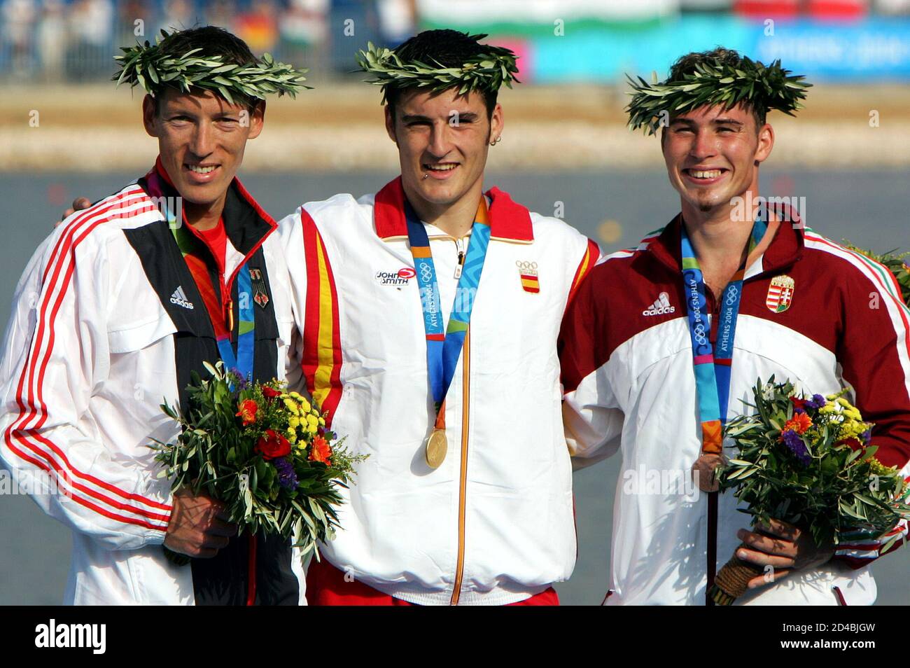 Spain's Olympic champion David Cal (C) wears his gold medal as he stands on the podium with Germany's silver medallist Andreas Dittmer (L) and Hungary's bronze winner Attila Vajda (R) after the men's C1 1000 metres finals at the Athens 2004 Olympic Summer Games August 27, 2004. Stock Photo