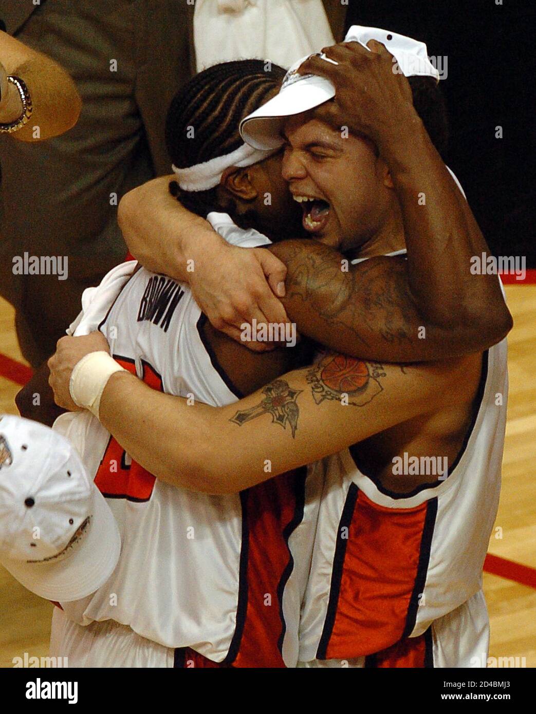 University of Illinois guards Dee Brown (L) and Deron Williams hug after defeating the University of Arizona in the Men's NCAA Chicago Regional Final March 26, 2005 in Rosemont, Illinois. Illinois defeated Arizona 90-89 in overtime to advance to the Final Four next week. REUTERS/Dave Kaup  FJP Stock Photo