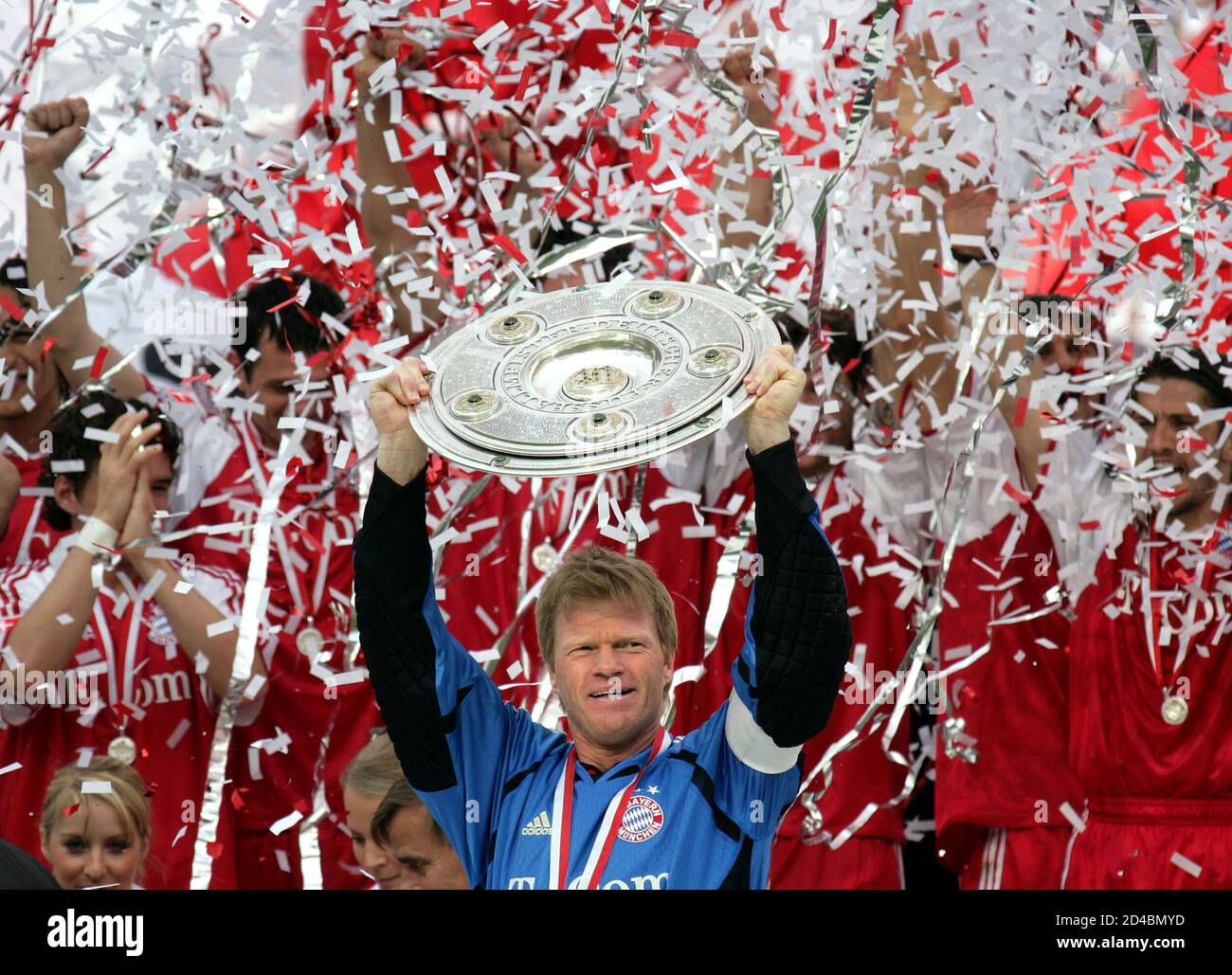 Oliver Kahn, team captain and goalkeeper of Bayern Munich holds up the  German first division soccer league Bundesliga champions trophy after his  team's match against [Nuremberg] in Munich's Olympic stadium, May 14,