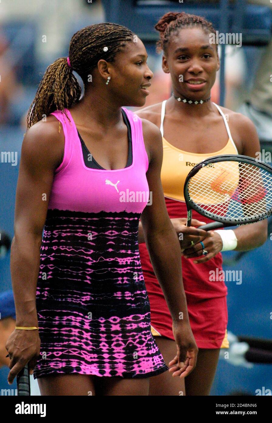 Serena Williams (L) and sister Venus of the United States take the court in  their doubles match against Kristie Boogert and Miriam Oremans of the  Netherlands at the U.S. Open in New