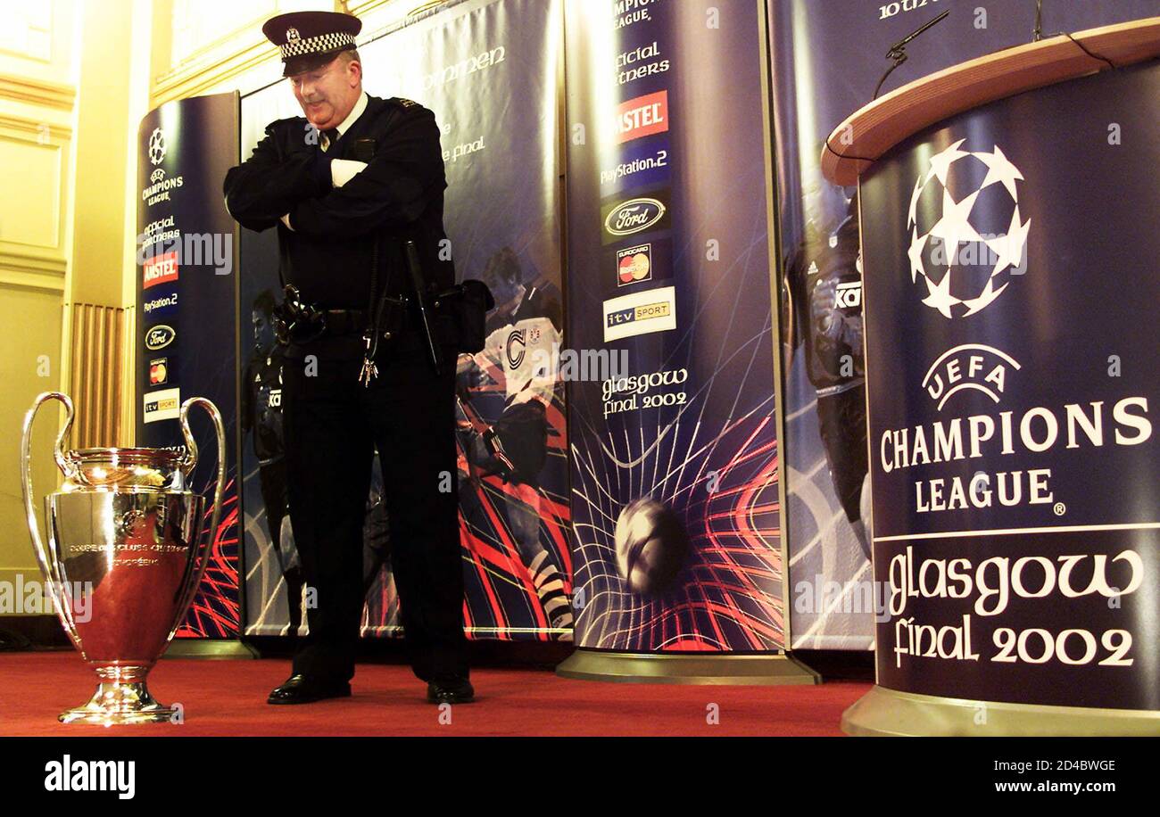 Constable Gordon Aitken stands guard over the Champions League Club Cup at Glasgow's City Chambers in Scotland April 11, 2002. [The Champions League trophy was returned by defending champions Bayer Munich to the Lord of Provost, Alex Mosson, for safe keeping in Glasgow ahead of the Champions League Final on May 15, 2002 at Hampden Park.] Stock Photo