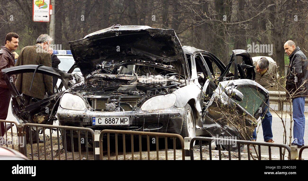 Bulgarian plainclothes policemen ivestigate an explosion that blew up a Mercedes car, killing the passanger and injuring the driver on Sofia's central Tsarigradsko Shosse boulevard on April 18, 2003. Police closed the six-lane boulevard and launched investigation into the case. REUTERS/Stoyan Nenov  SN/ Stock Photo