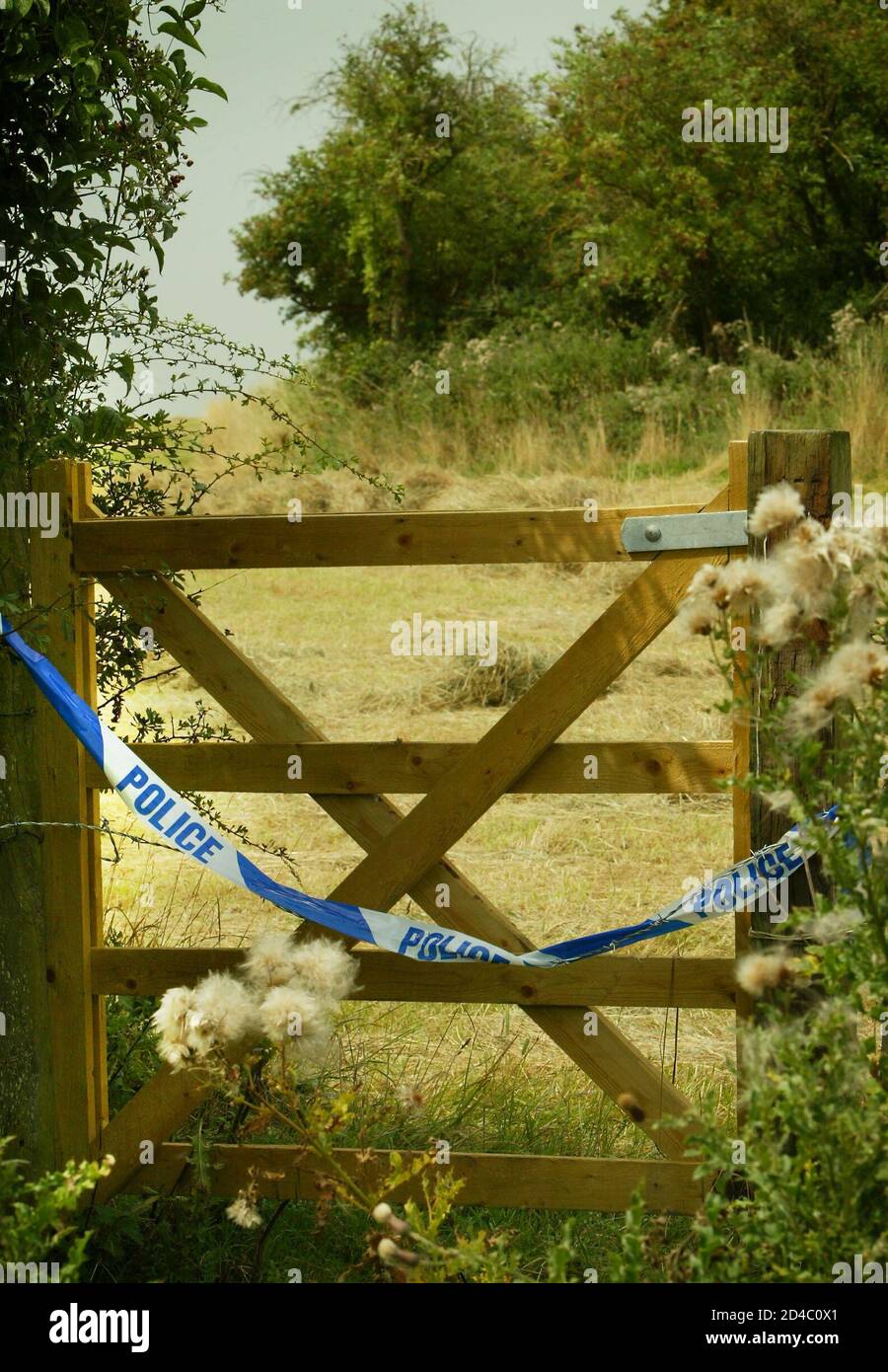 British police tape marks the entrance to woodland on August 5, 2003, where British government scientist Dr David Kelly's body was found on Harrowdown Hill near Southmoor in Oxfordshire. Britain's Prime Minister Tony Blair's official spokesman Tom Kelly admitted on Tuesday smearing Dr Kelly, whose funeral takes place on August 6 and whose suicide over the case for war in Iraq sparked the worst crisis in Blair's premiership. Tom Kelly acknowledged that he had made comments in an off-the-record briefing comparing the scientist with fictional fantasist Walter Mitty, a character with delusions of  Stock Photo