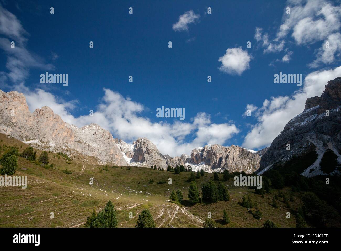 Views of hiking trails and trees, with the peaks of the Geisler group of mountains in the Italian Dolomites, in the Alps, South Tyrol, Italy Stock Photo