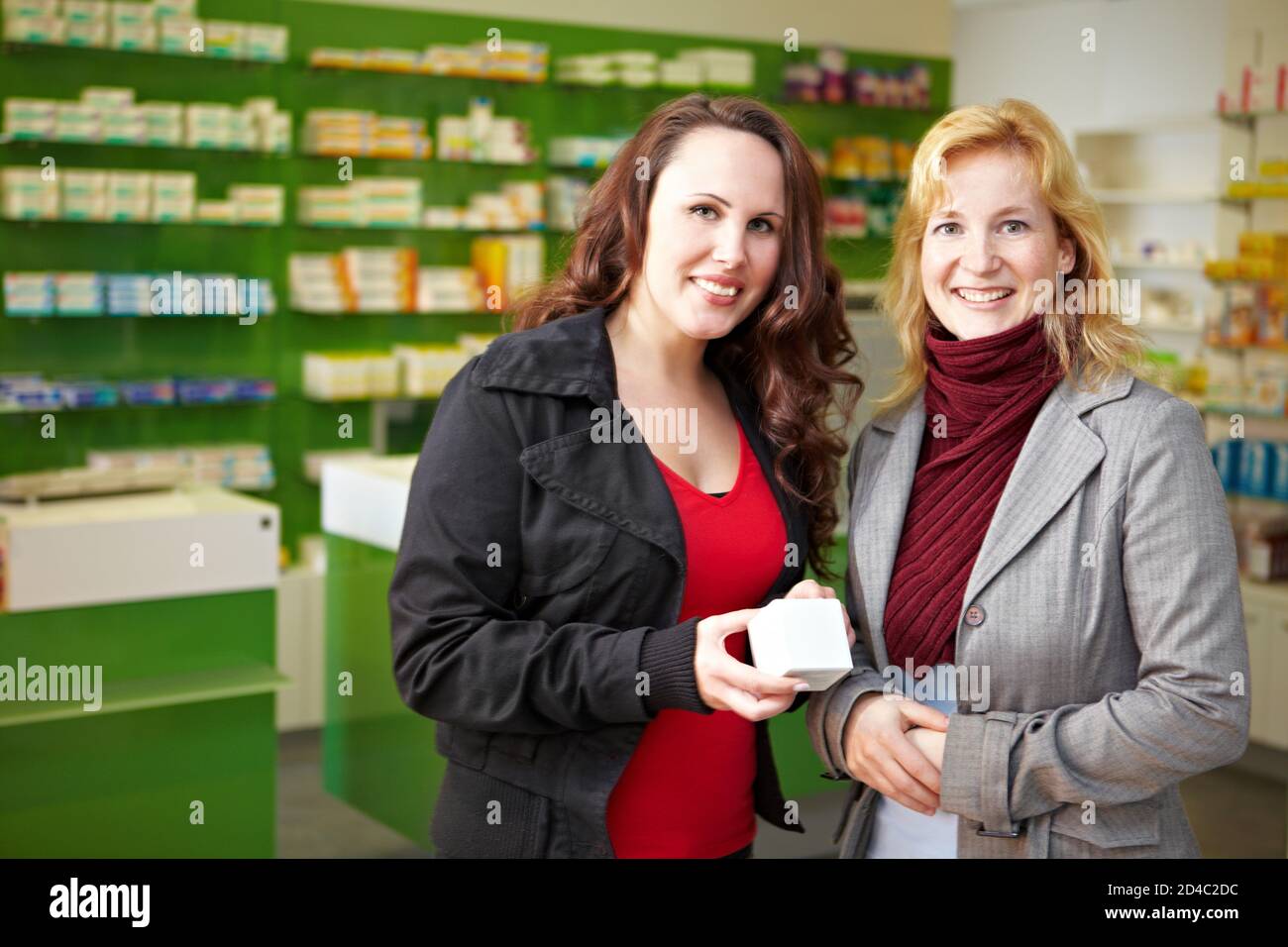 Two women stand with medicine in a pharmacy Stock Photo Alamy