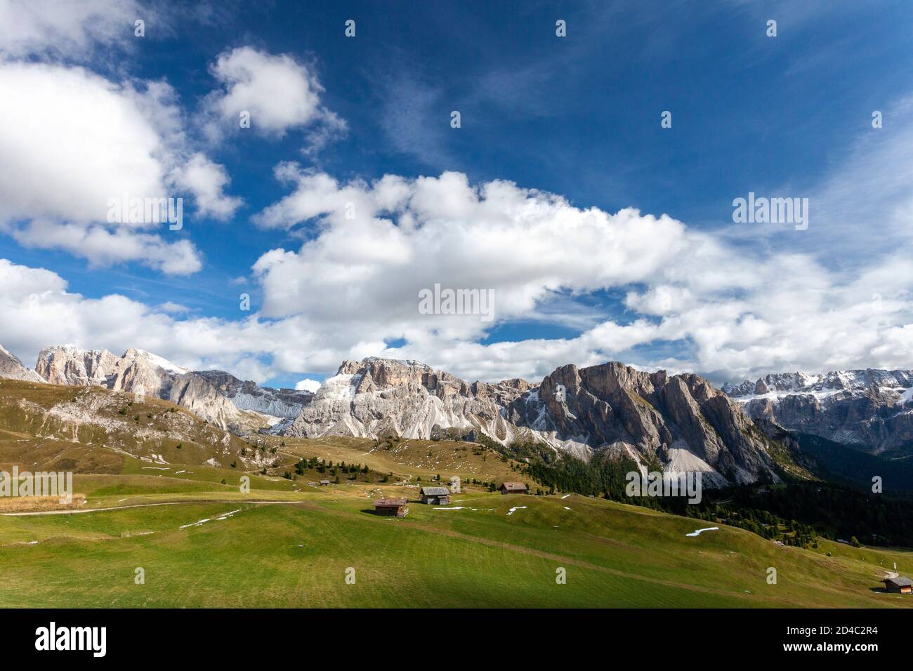 A view of the Italian Dolomites Geisler group of peaks, with places to stay scattered through the valley, reachable from the Furnes-Seceda cableway Stock Photo