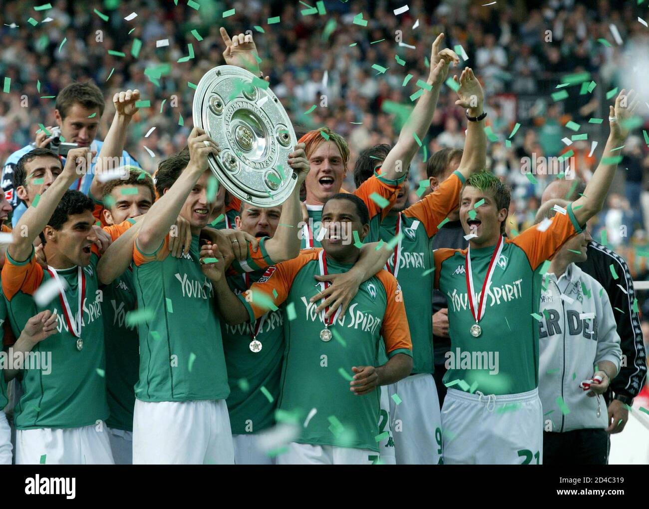 Werder Bremen's players celebrate with the German Bundesliga trophy in  Bremen after their match [against Bayer Leverkusen which they lost 2-6],  May 15, 2004. [Werder Bremen sealed their fourth Bundesliga title with