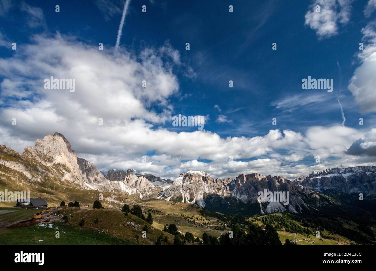 A view of the Italian Dolomites Geisler group of peaks, with places to stay scattered through the valley, reachable from the Furnes-Seceda cableway Stock Photo