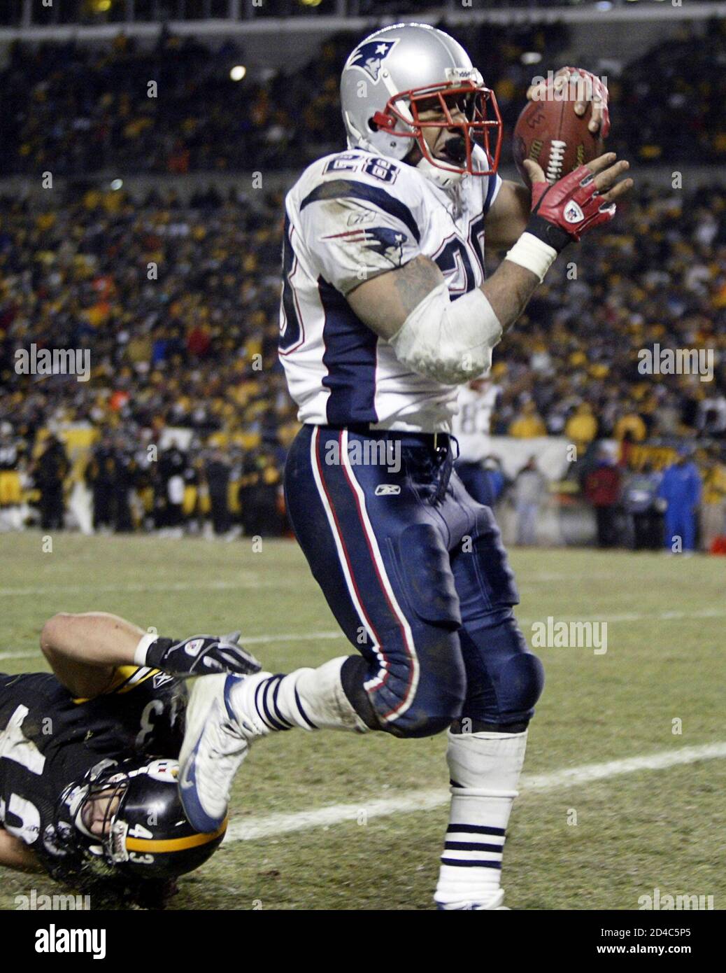 Patriots Dillions breaks tackle to score touchdown against Steelers during AFC  championship game in Pittsburgh. New England Patriots running back Corey  Dillion (R) breaks a tackle by Pittsburgh Steelers safety Troy Polamalu (