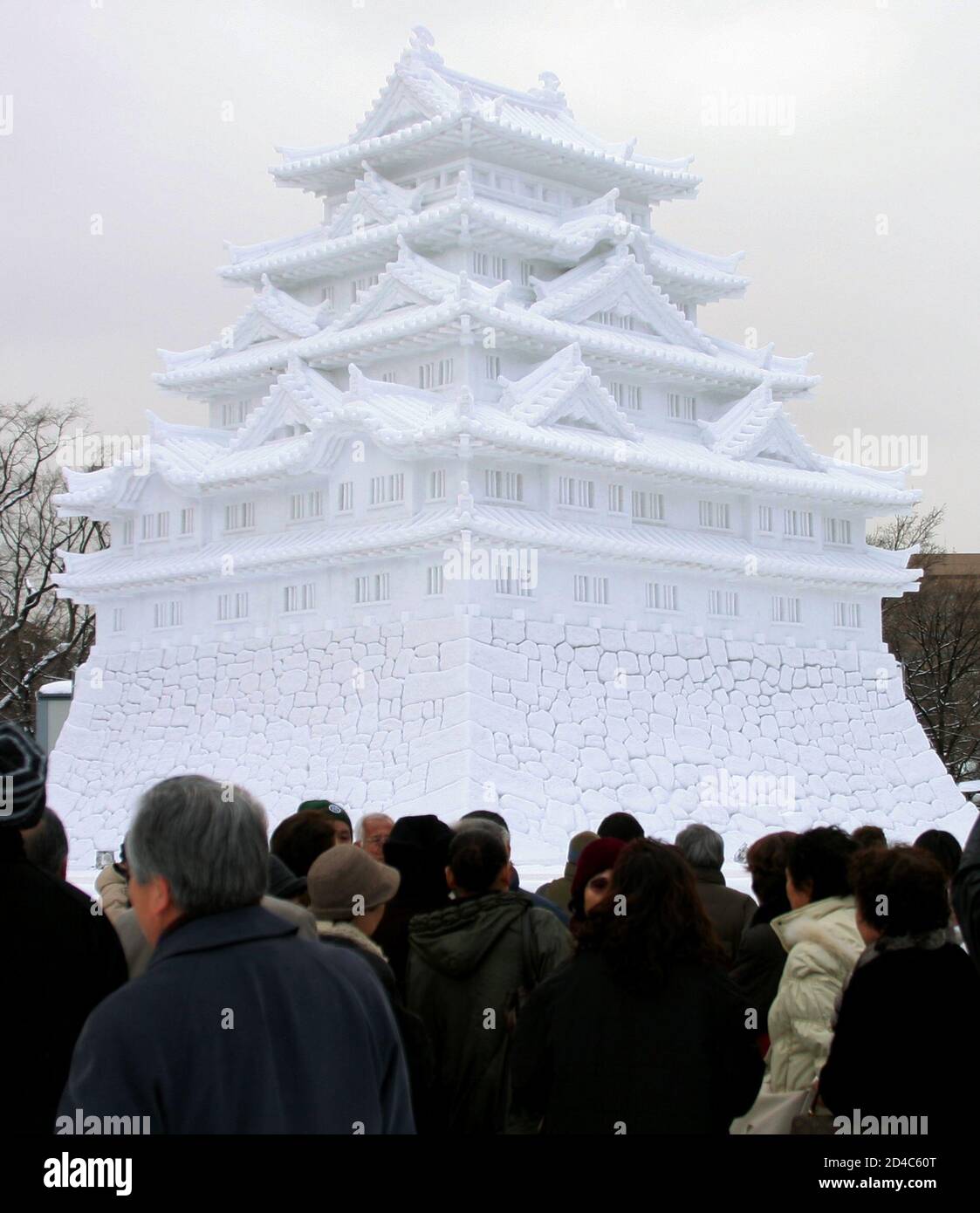 Japanese Tourists Gather In Front Of A Large Snow Statue Of Nagoya Castle At The Sapporo Snow Festival In Hokkaido Japanese Tourists Gather In Front Of A Large Snow Statue Of Nagoya