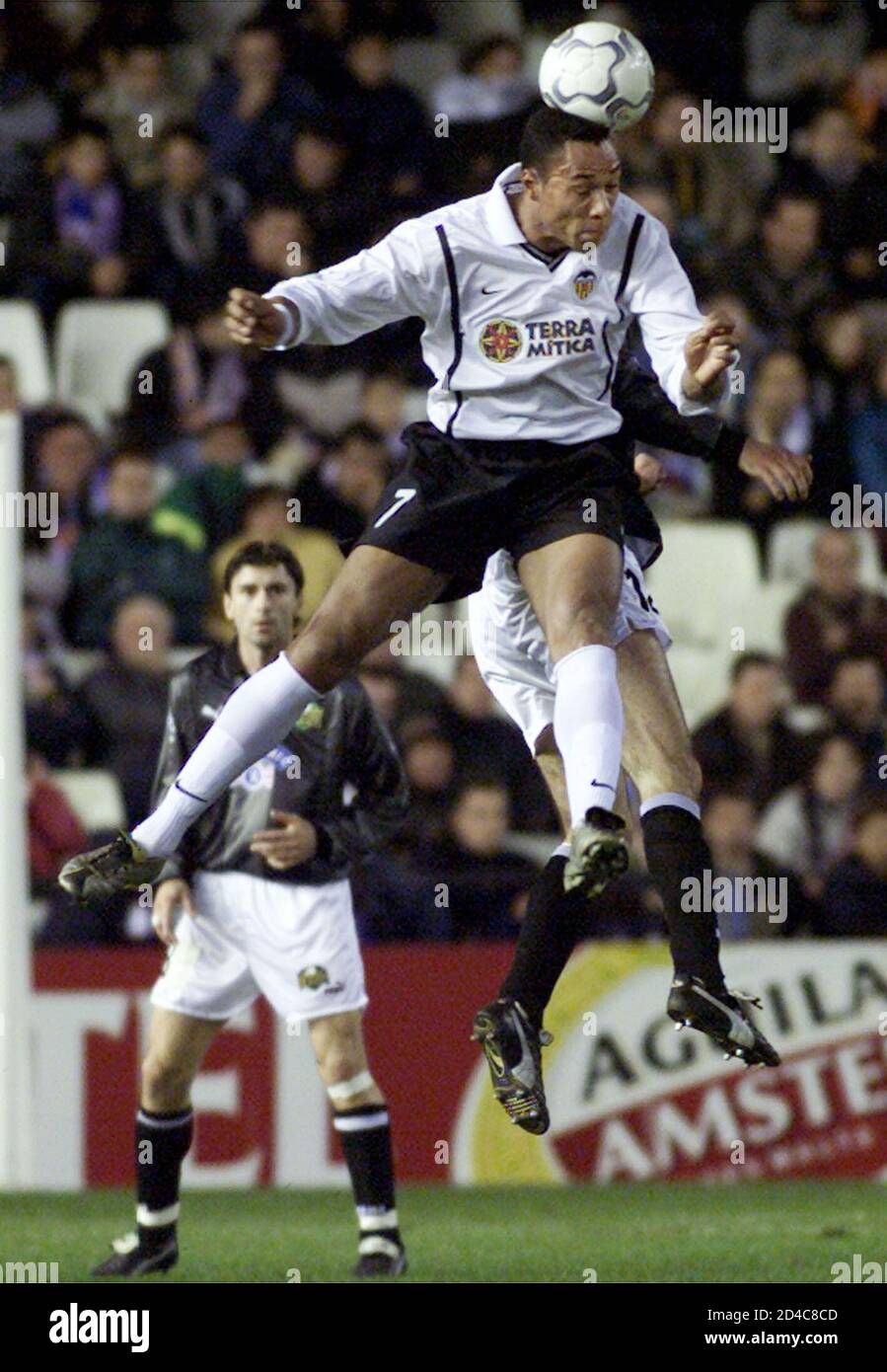 Valencia's Norwegian striker Jonh Carew jumps for the ball (L) with SK Sturm  Graz Gilbert Prilasnig during their Champions League group A soccer match  at Valencia's Mestalla stadium November 21, 2000. AC