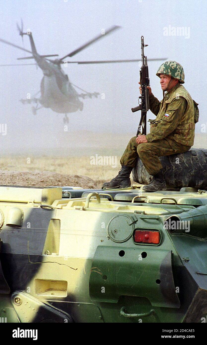 Russian Soldier Sits On Apc As A Helicopter Takes Off As He Patrols The Tajik Afghan Border In The Tajik Region Of Kholkayar November 15 2001 Tajikistan Which Has Military Air Bases Used