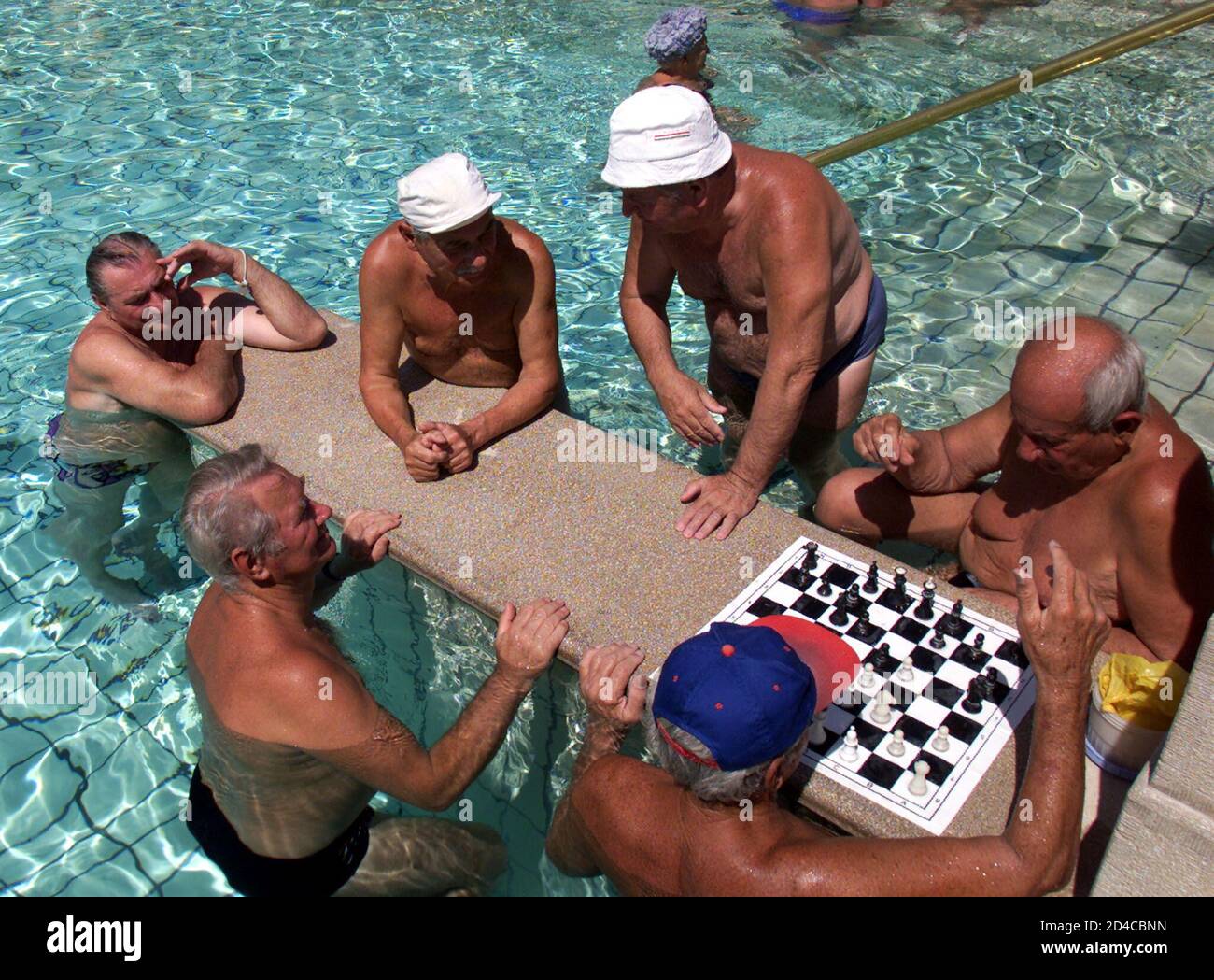 Hungarians play chess as they cool off at Budapest's 19th century Szechenyi bath and spa on June 14, 2002. Temperatures in Budapest, the European capital with the most spas, are expected to reach 40C this weekend. REUTERS/Laszlo Balogh  LB Stock Photo