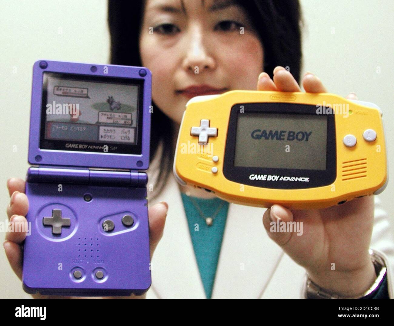 A Nintendo Co Employee Displays The Company S New Game Boy Advance Sp L And The Current Version In Osaka Western Japan On January 7 03 Japan S Videogame Giant Said On Tuesday That