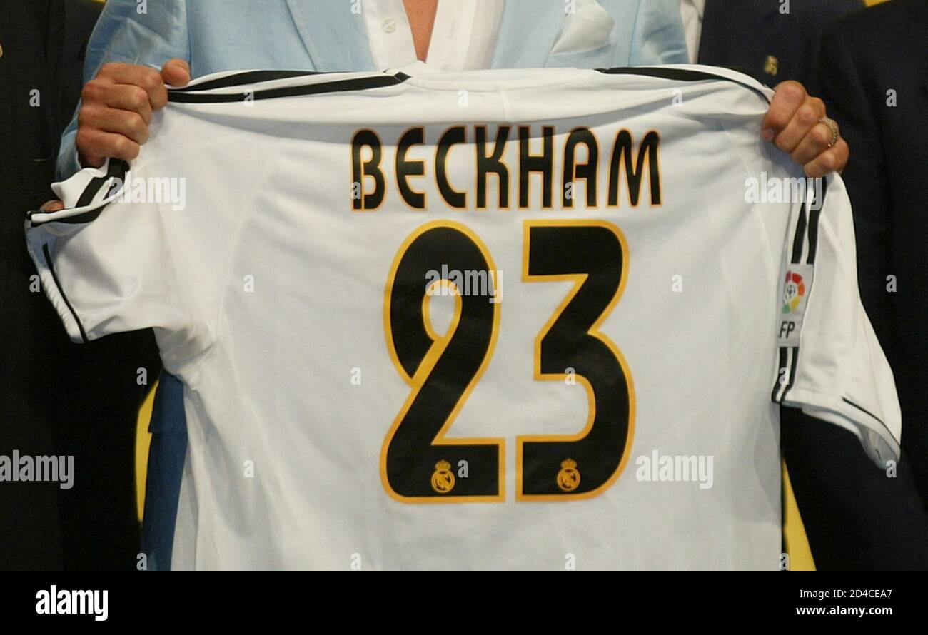 Real Madrid's new signing David Beckham holds his new team shirt in Madrid  July 2, 2003. Real Madrid paid 35 million euros for the midfielder to move  from Manchester United. REUTERS/Felix Ordonez