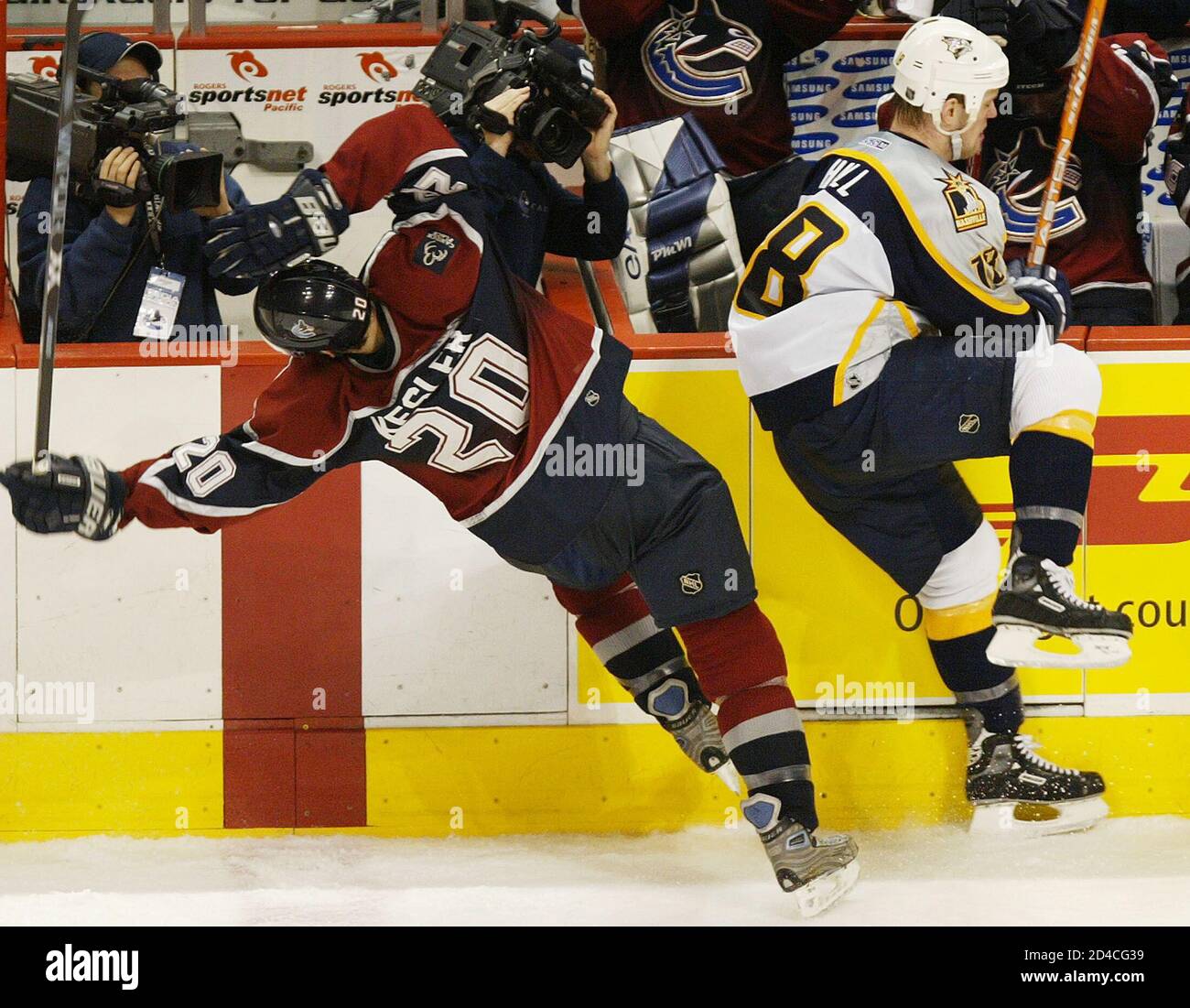 vancouver-canucksryan-kesler-l-is-checked-by-nashville-predatorsadam-hall-during-the-second-period-of-their-nhl-game-in-vancouver-british-columbia-march-16-2004-reuterslyle-stafford-ls-2D4CG39.jpg