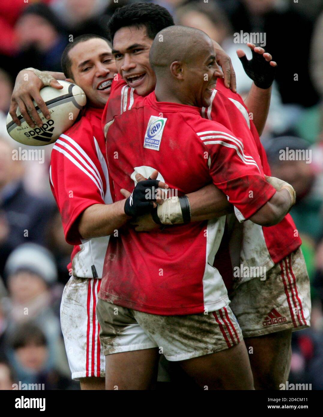 Gregan and Drahm celebrate with Sititi from the southern hemisphere after  Sititi scored a try in their tsunami benefit rugby union match at  Twickenham in London. Southern hemisphere players Australia's George Gregan  (
