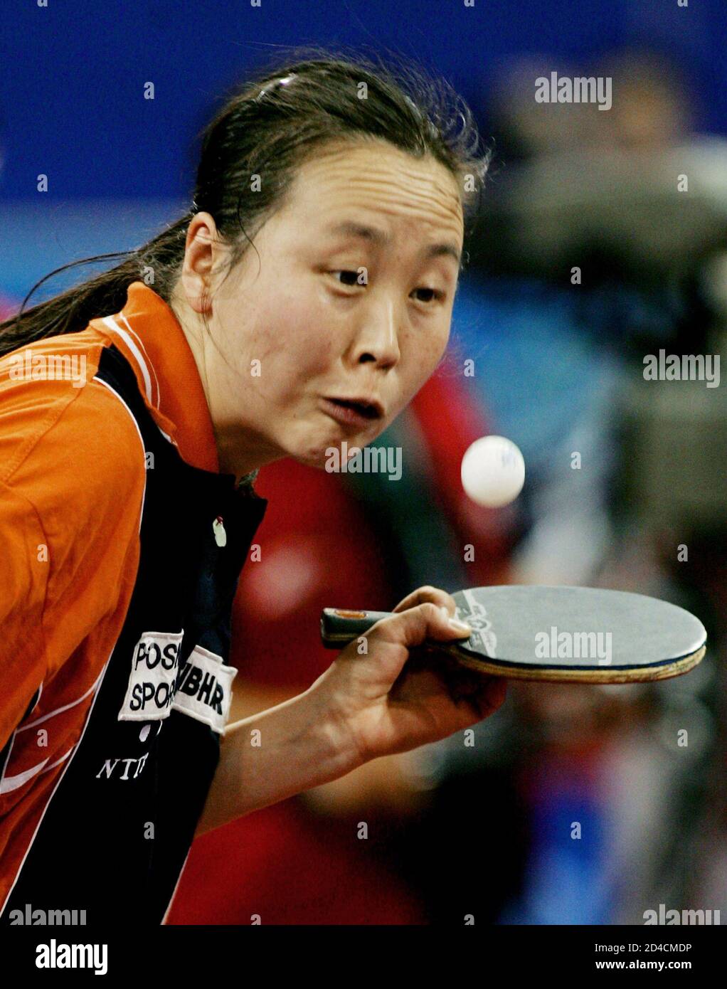 Li Jiao of the Netherlands serves at the women singles round four match against [Moon Hyun-jung of South Korea] at the 48th World Table Tennis Championship in Shanghai, China, May 4, 2005. Li won 4-3. Stock Photo
