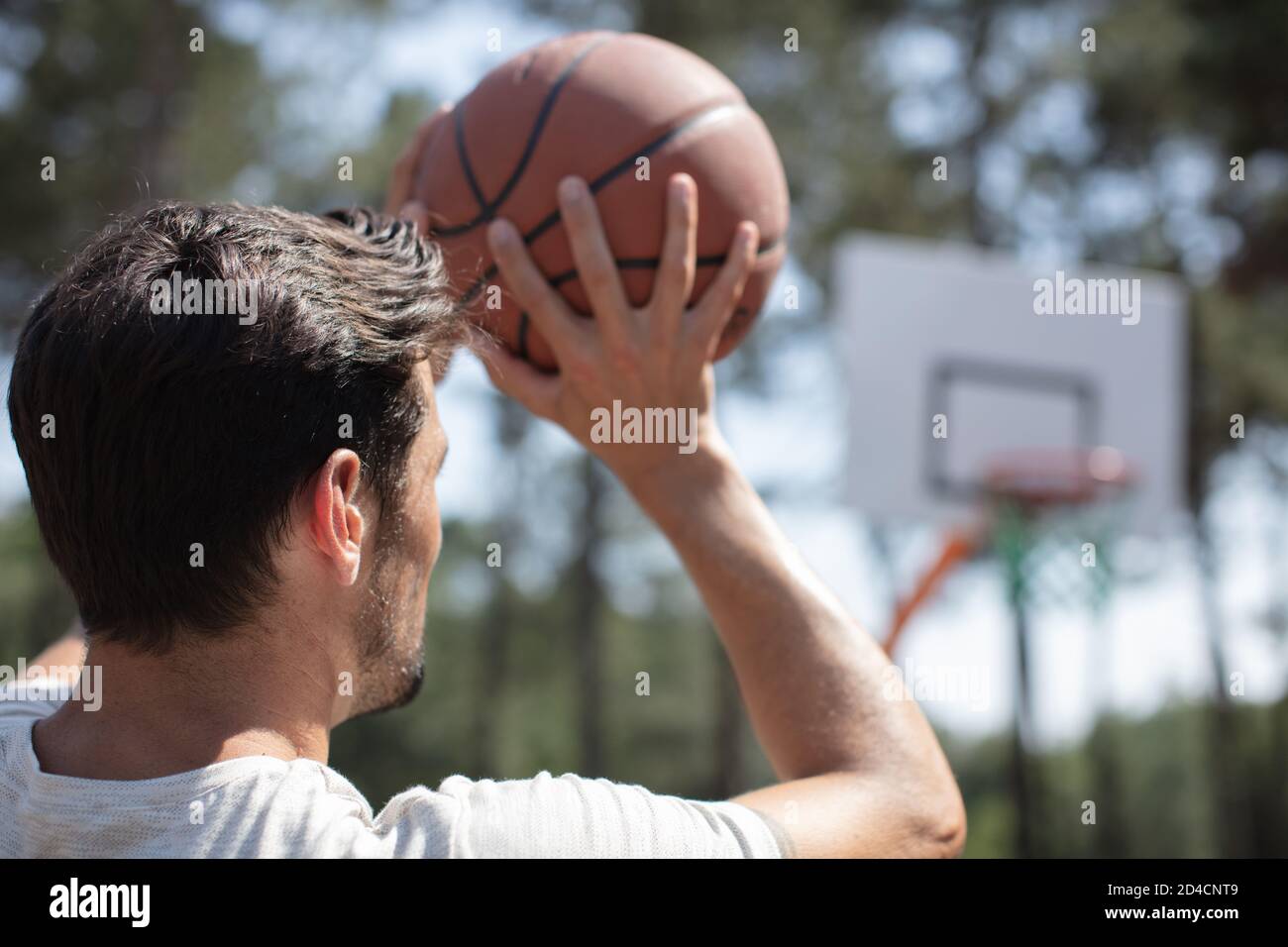 young man shooting free throws from the foul line Stock Photo Alamy