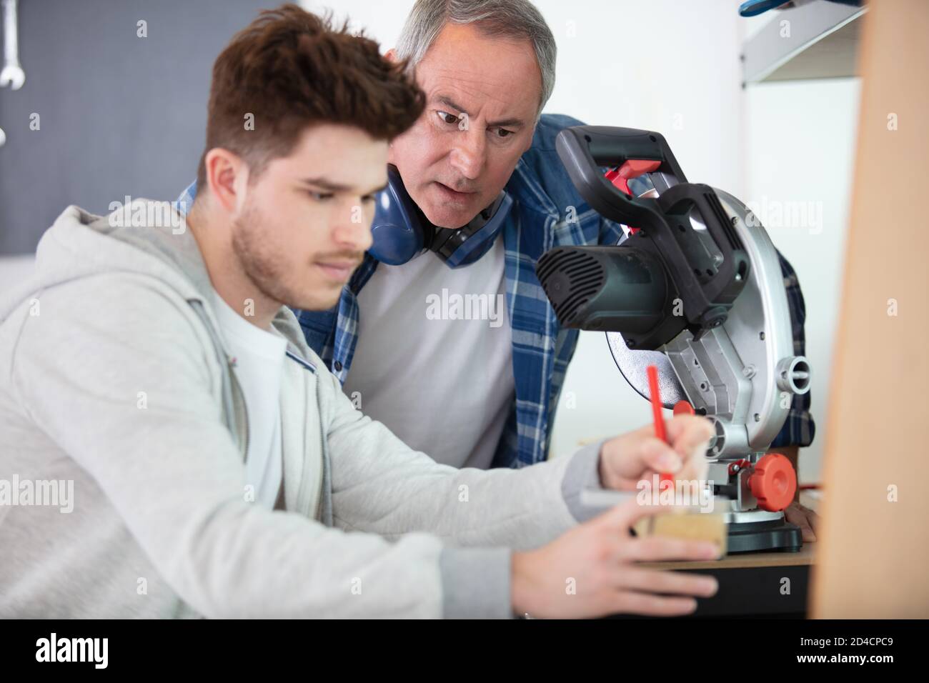 student in carpentry class using circular saw Stock Photo