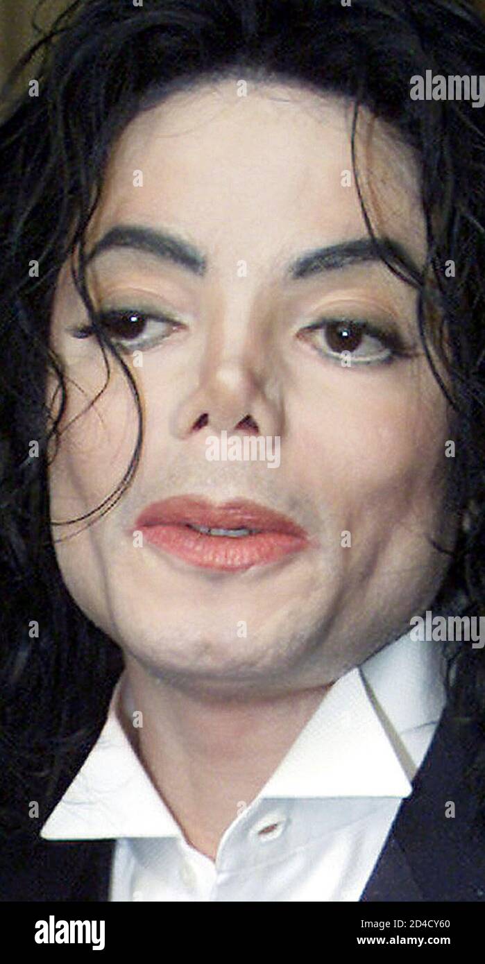 U.S. pop singer Michael Jackson answers questions from the media on arrival  at the House of Lords at the Palace of Westminster in central London, June  14, 2002. [Jackson is on a